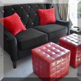F23. Black velvet wingback loveseat (37”h x 60”w x 36”d) and pair of red quilted cubes (each 17”h x 16”w x 16”d) 